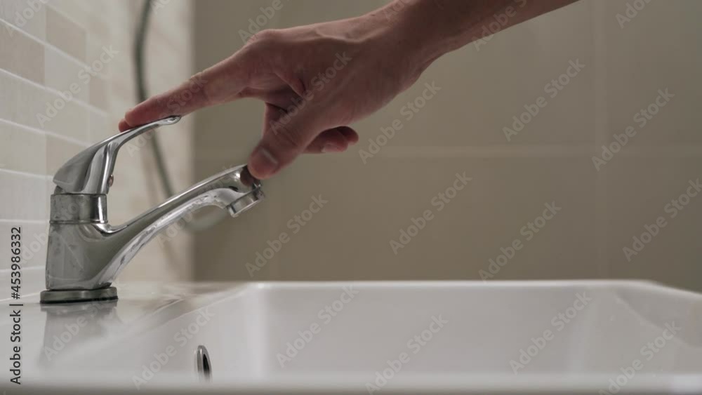 use hand closes water tap. Turning off the water when not in use saves energy and reduces global warming. Concept save energy save water...