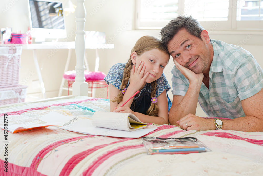 Father helping daughter with homework