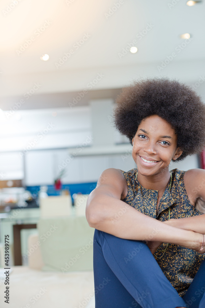 Smiling woman sitting in living room Smiling woman sitting in living room