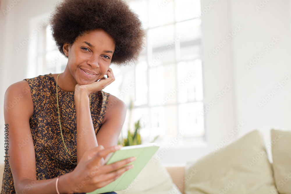 Woman using digital tablet on sofa Woman using digital tablet on sofa