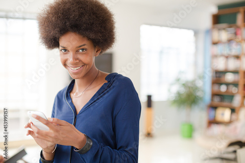 Woman using cell phone in living room