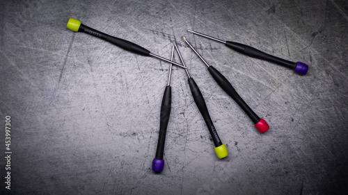colored screwdrivers on an abstract background