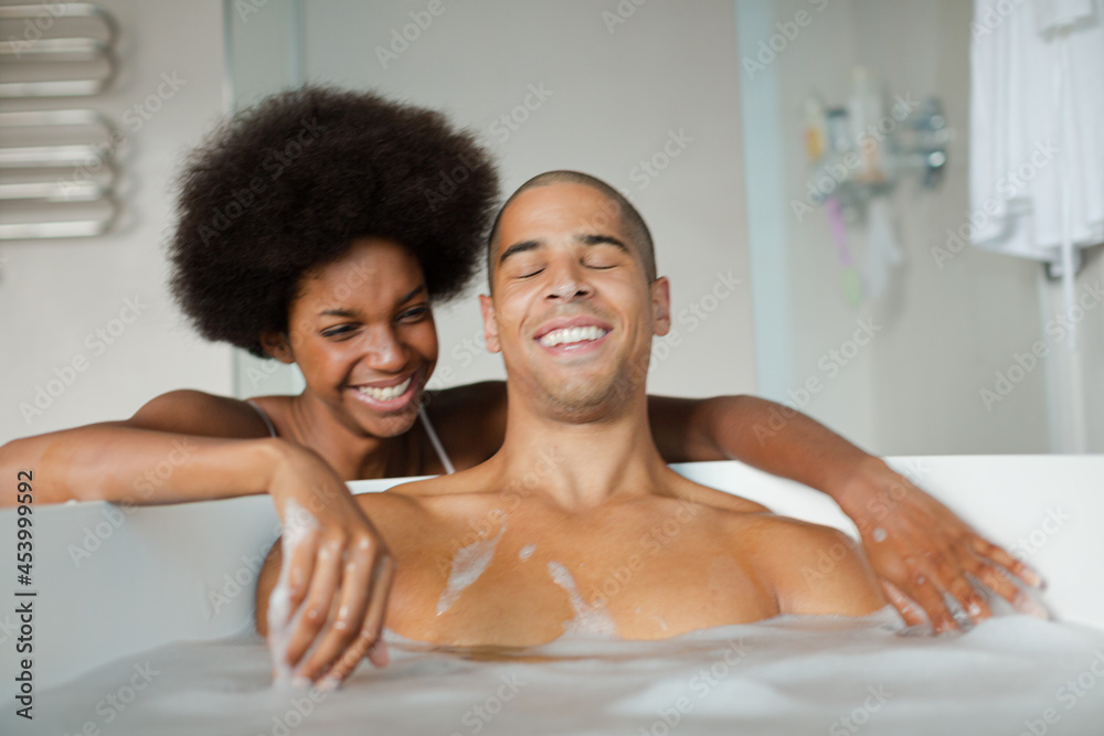 Woman playing with boyfriend in bubble bath Woman playing with boyfriend in bubble bath