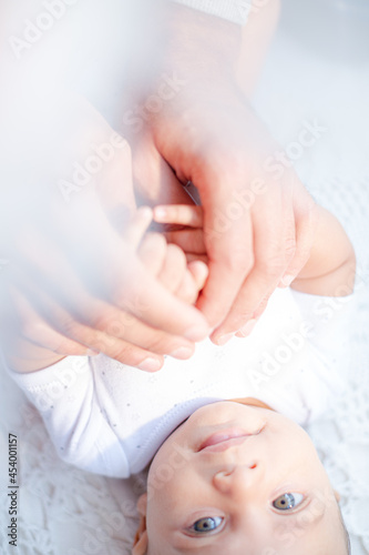 Father holding baby boy's hands