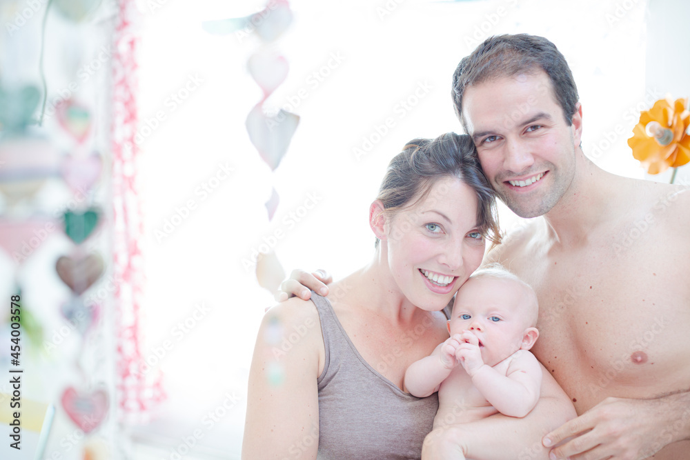 Parents and baby girl smiling together Parents and baby girl smiling together