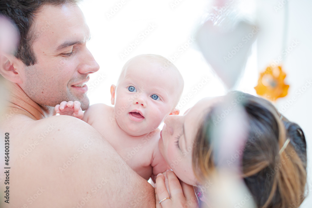 Parents kissing baby girl's cheeks Parents kissing baby girl's cheeks