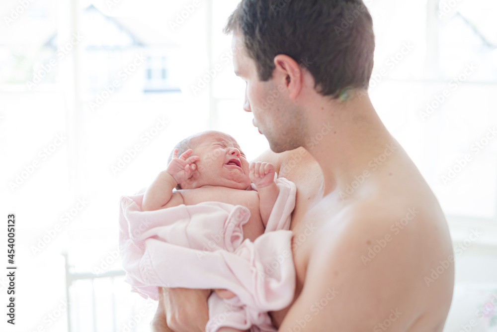 Father holding crying baby girl Father holding crying baby girl