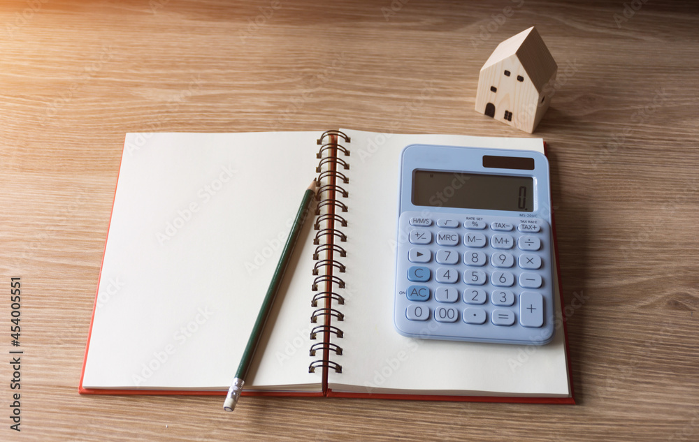 Calculator with notebook and other on wooden table,selective focus. Calculator with notebook and other on wooden table,selective focus.