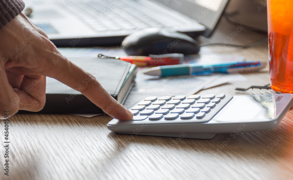 Hand of business man using calculator,soft focus. Hand of business man using calculator,soft focus.