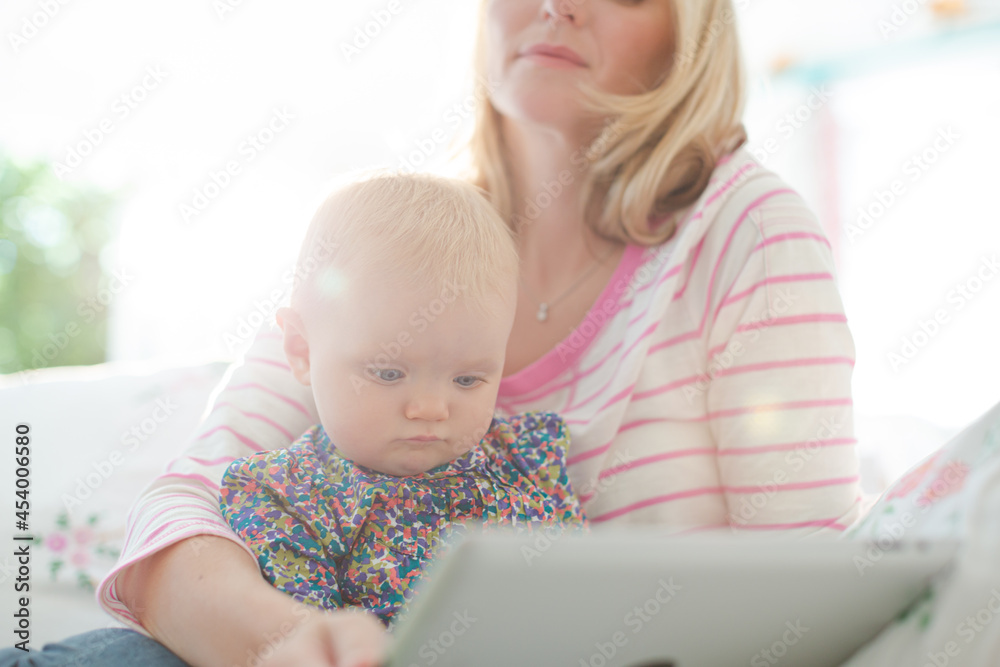 Mother and baby girl using digital tablet Mother and baby girl using digital tablet