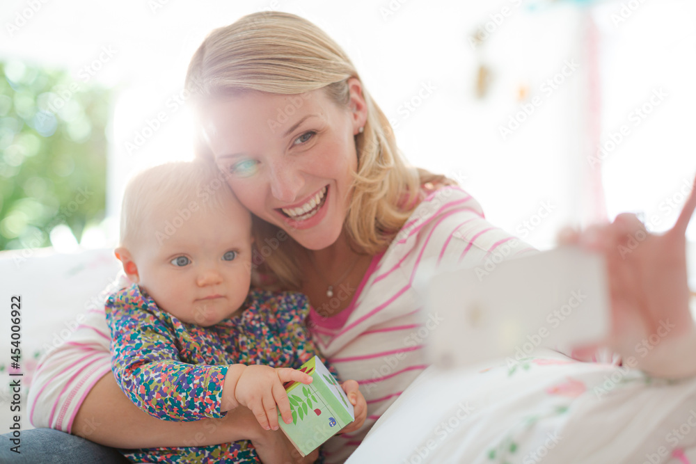 Mother taking self-portrait with baby girl Mother taking self-portrait with baby girl