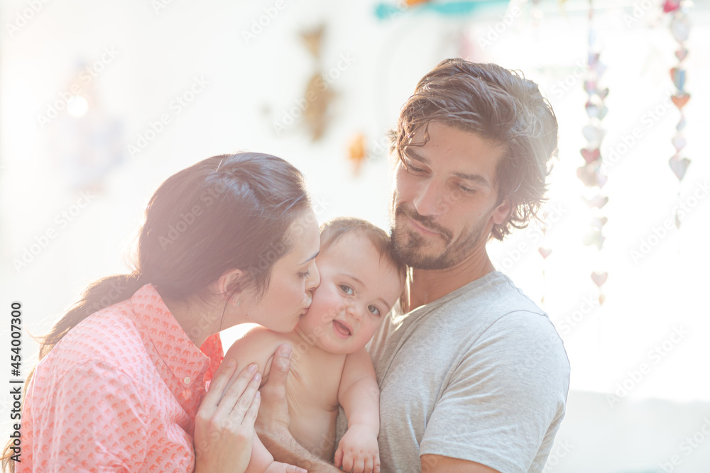 Obraz premium Parents smiling with baby boy