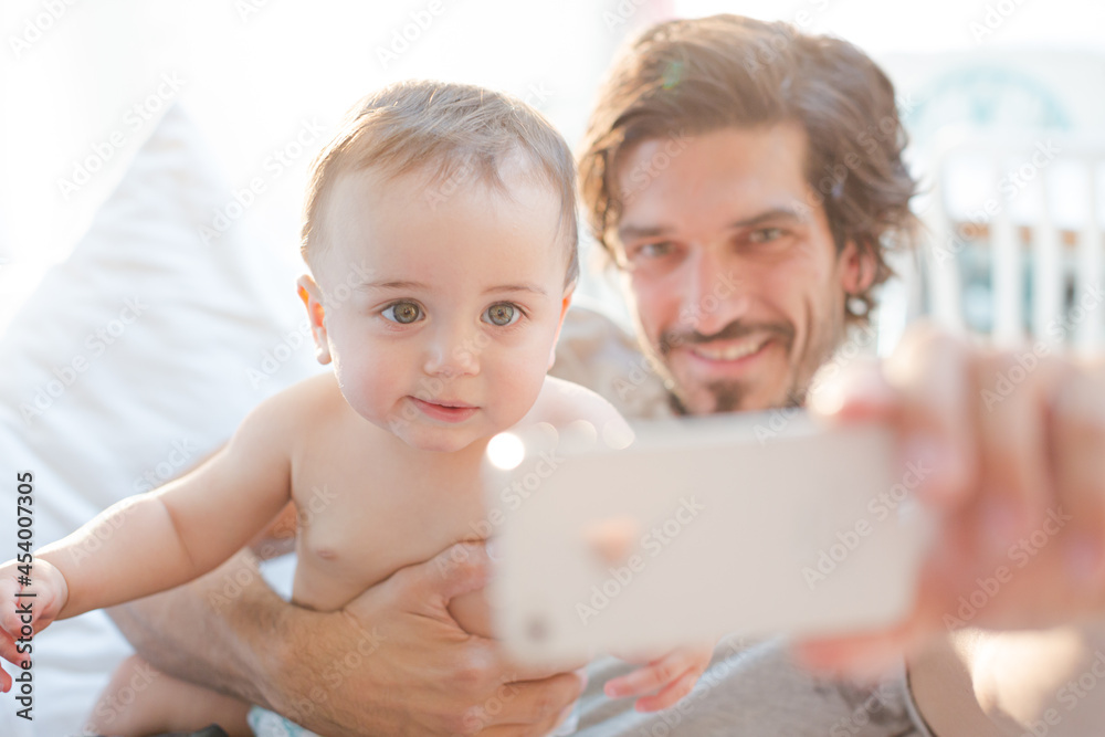 Father taking self-portrait with baby boy Father taking self-portrait with baby boy