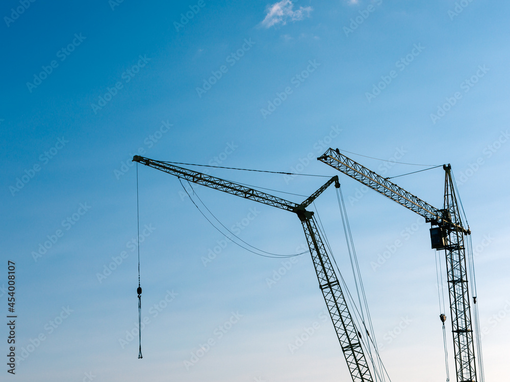 construction site with cranes against the background of new buildings construction site with cranes against the background of new buildings