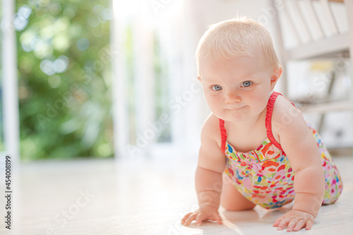 Baby girl crawling on floor