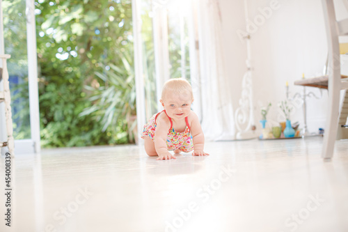 Baby girl crawling on floor