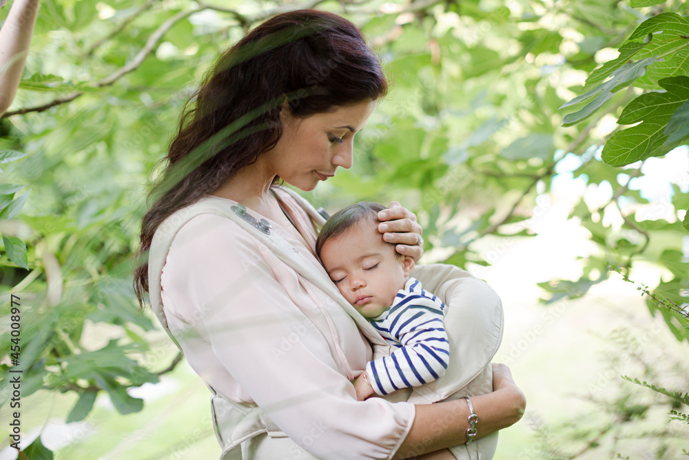 Mother holding baby boy outdoors Mother holding baby boy outdoors