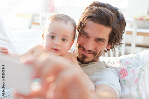 Father taking self-portrait with baby boy