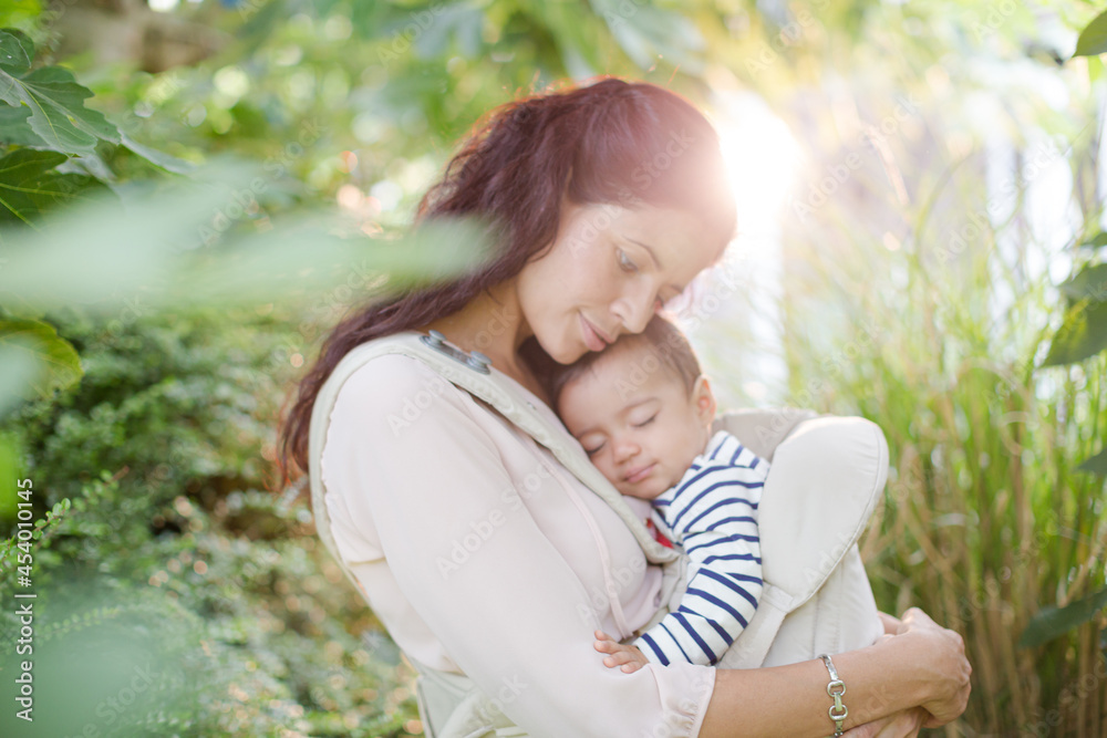 Mother holding baby boy outdoors Mother holding baby boy outdoors