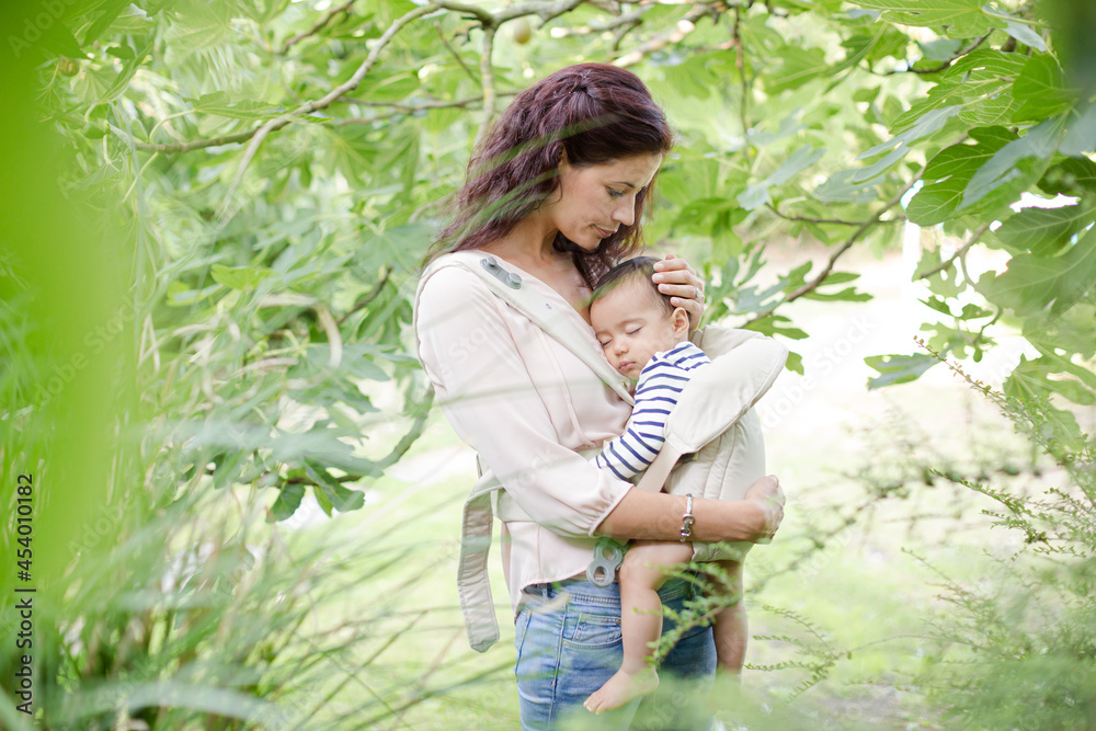 Mother holding baby boy outdoors Mother holding baby boy outdoors