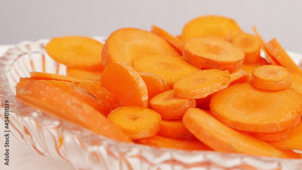 Side view of small slices of carrot placed in transparent glass bowl Side view of small slices of carrot placed in transparent glass bowl