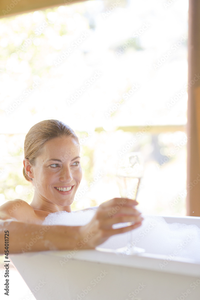 Woman having champagne in bubble bath Woman having champagne in bubble bath