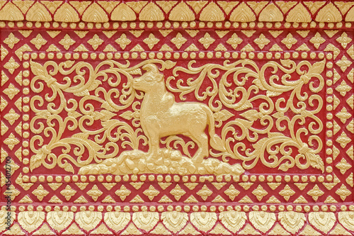 Traditional Thai style stucco or high-relief sculpture of cow of 12 Zodiac,on the wall of temple in Thailand