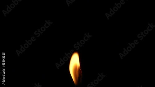 Closeup candle fire flame isolated burning on black background, slow motion HD photo