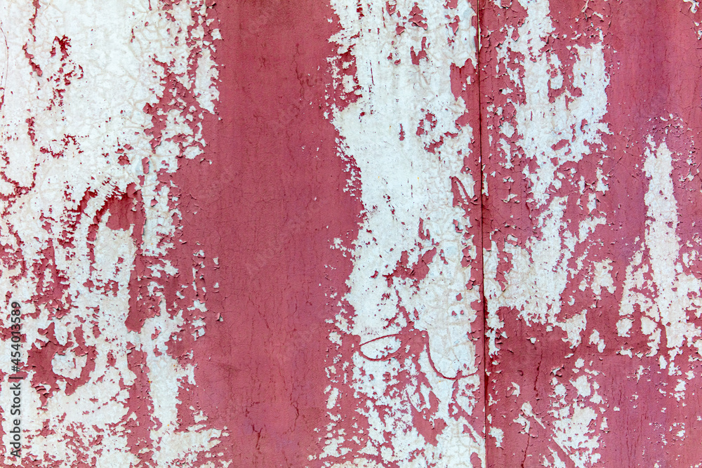 Naklejka premium Old painted cracked wall as an abstract background.