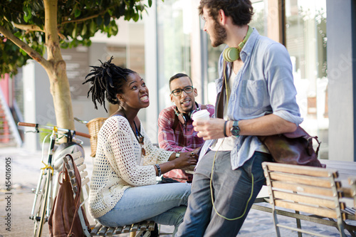 Friends talking at sidewalk cafe © KOTO