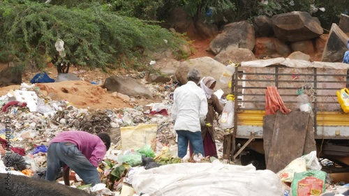 Rag pickers collecting recyclable items at dumping yard
