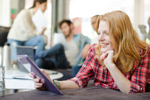 Woman using digital tablet in cafe