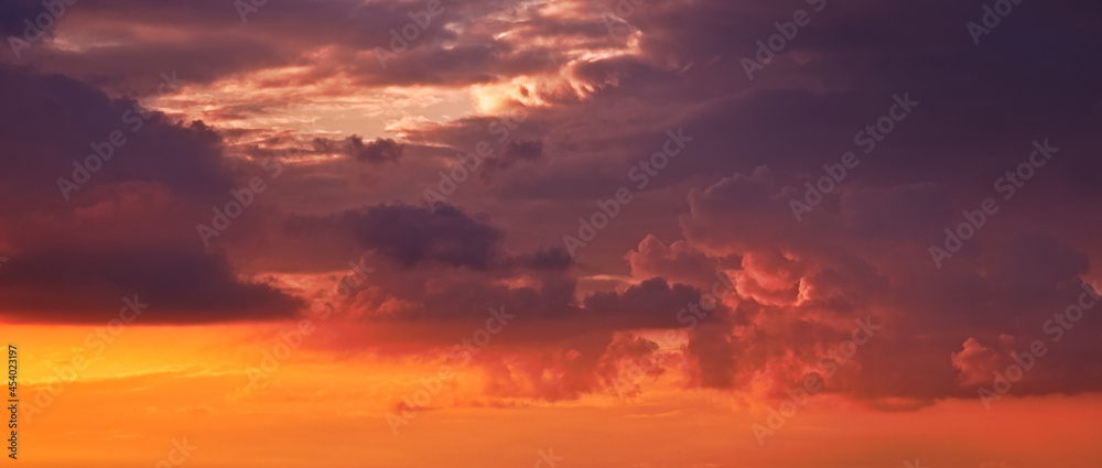 A dramatic sky with clouds during the sunset.