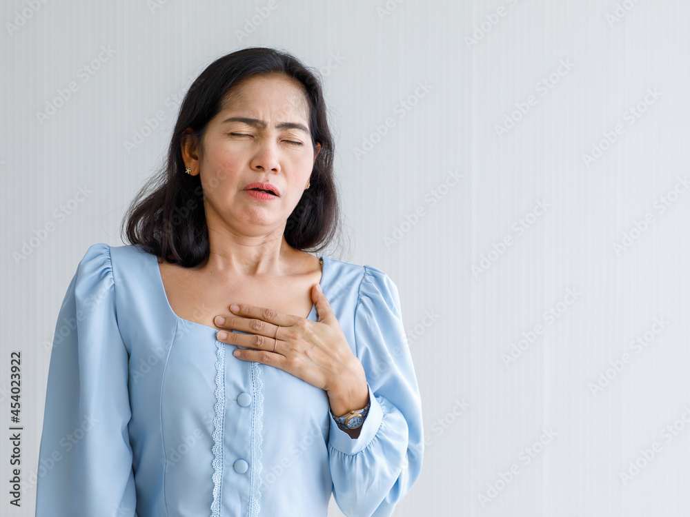 Adult woman with sudden heart attack and hold chest with pain face. Concept of emergency health care and affected from Congestive Failure or Cardiopulmonary Resuscitation, heart problem Adult woman with sudden heart attack and hold chest with pain face. Concept of emergency health care and affected from Congestive Failure or Cardiopulmonary Resuscitation, heart problem