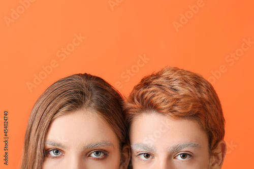 Teenagers with dyed eyebrows on color background
