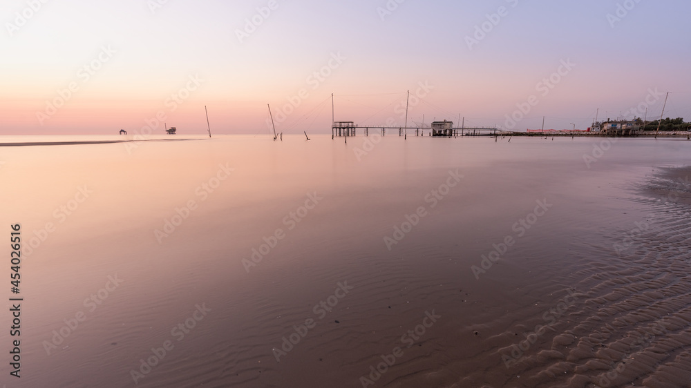 Landscape view of fishing huts at sunrise