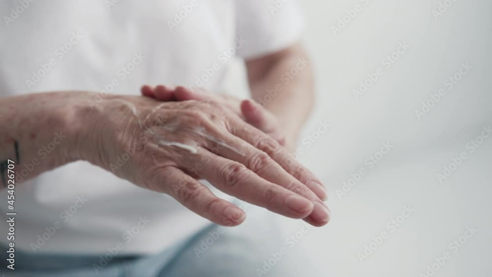 Elderly Adult Female Hands Care Cream Close-up. Concept Anti-Aging Nature Cosmetics. Aged Lady Apply Cream on Skin and Massage Arm for Softness. Daily Moisturising Hydration Vitamin Mature Age Creme Elderly Adult Female Hands Care Cream Close-up. Concept Anti-Aging Nature Cosmetics. Aged Lady Apply Cream on Skin and Massage Arm for Softness. Daily Moisturising Hydration Vitamin Mature Age Creme