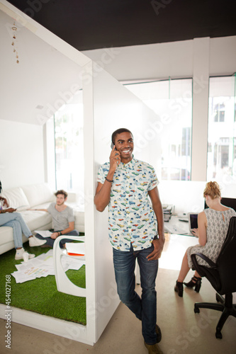 Man talking on cell phone in office © KOTO