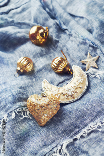 Christmas golden baubles on blue background. Close up. 