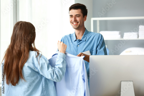 Male worker taking order fr...