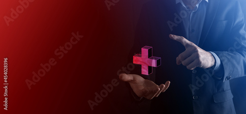 Businessman hold 3D plus icon, man hold in hand offer positive thing such as profit, benefits, development, CSR represented by plus sign.The hand shows the plus sign