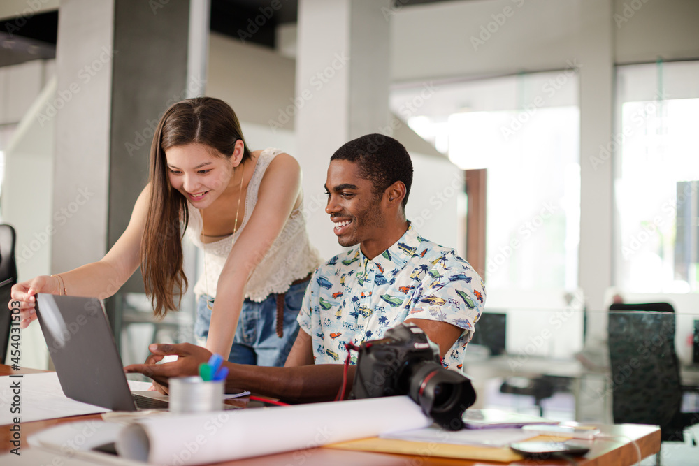People reviewing photos together in office