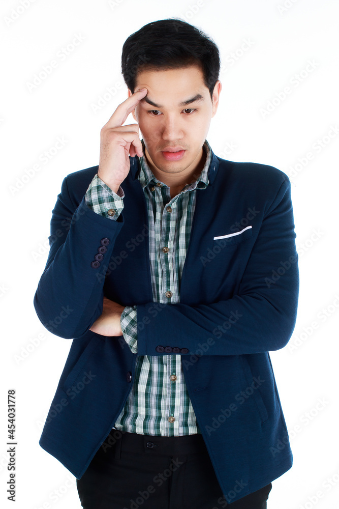 Portrait of a serious young businessman in dark blue suit with fingers rubbing on his temple, suffering from a terrible headache caused by business mistaken decision. Business concept. Portrait of a serious young businessman in dark blue suit with fingers rubbing on his temple, suffering from a terrible headache caused by business mistaken decision. Business concept.
