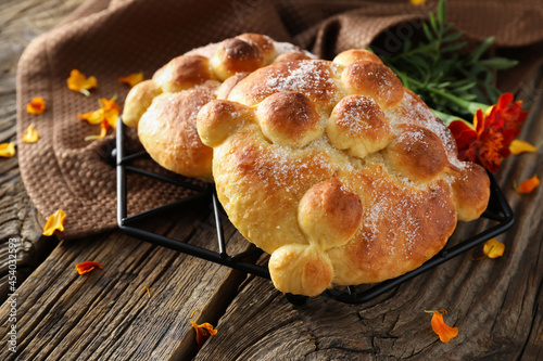 Bread of the dead on wooden background. Celebration of Mexico's Day of the Dead (El Dia de Muertos) photo