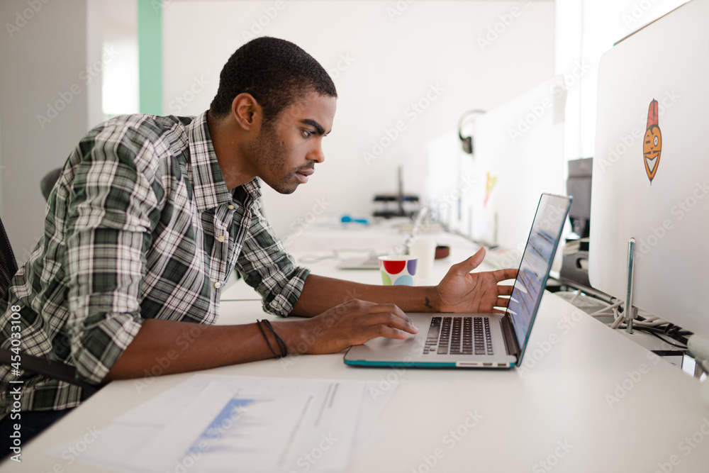 Man working on laptop at office Man working on laptop at office