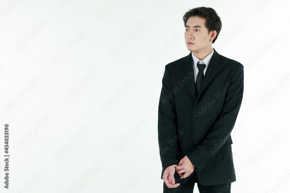 Portrait of self-confidence young and handsome Asian businessman arranging and adjust black suit with elegant pose with copy space studio shot isolated on white background Portrait of self-confidence young and handsome Asian businessman arranging and adjust black suit with elegant pose with copy space studio shot isolated on white background