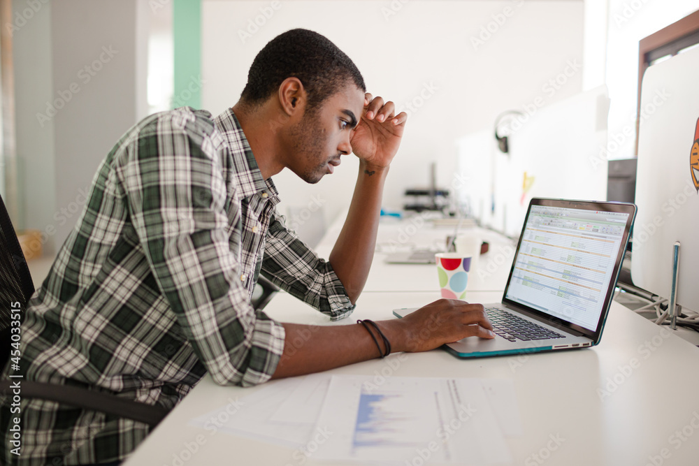 Man working on laptop at office Man working on laptop at office