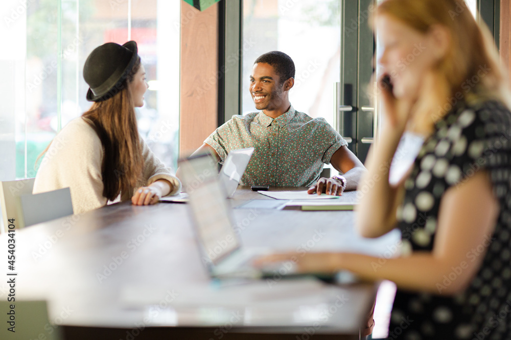 © KOTO - Woman working at conference table in office