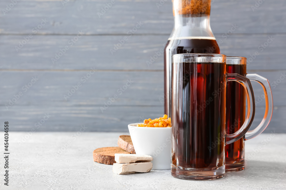 Mugs of fresh kvass on wooden background Mugs of fresh kvass on wooden background