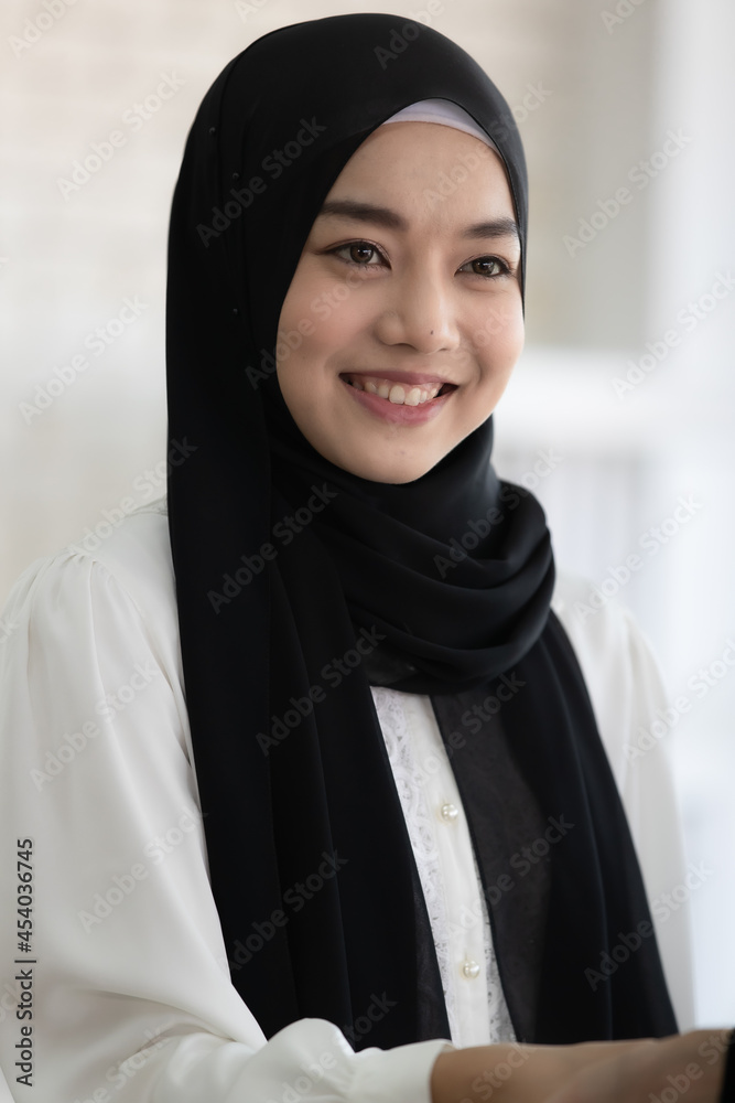 Muslim business girls wearing black hijab are using shaking hands in business deal. With a smiling face Business concept. Muslim business girls wearing black hijab are using shaking hands in business deal. With a smiling face Business concept.